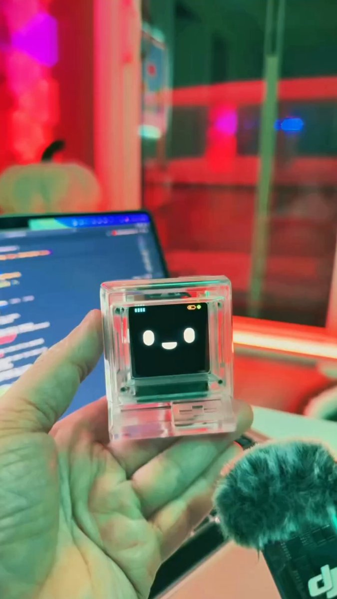 Small transparent ESP32-S3 box with an animated face on a colour screen